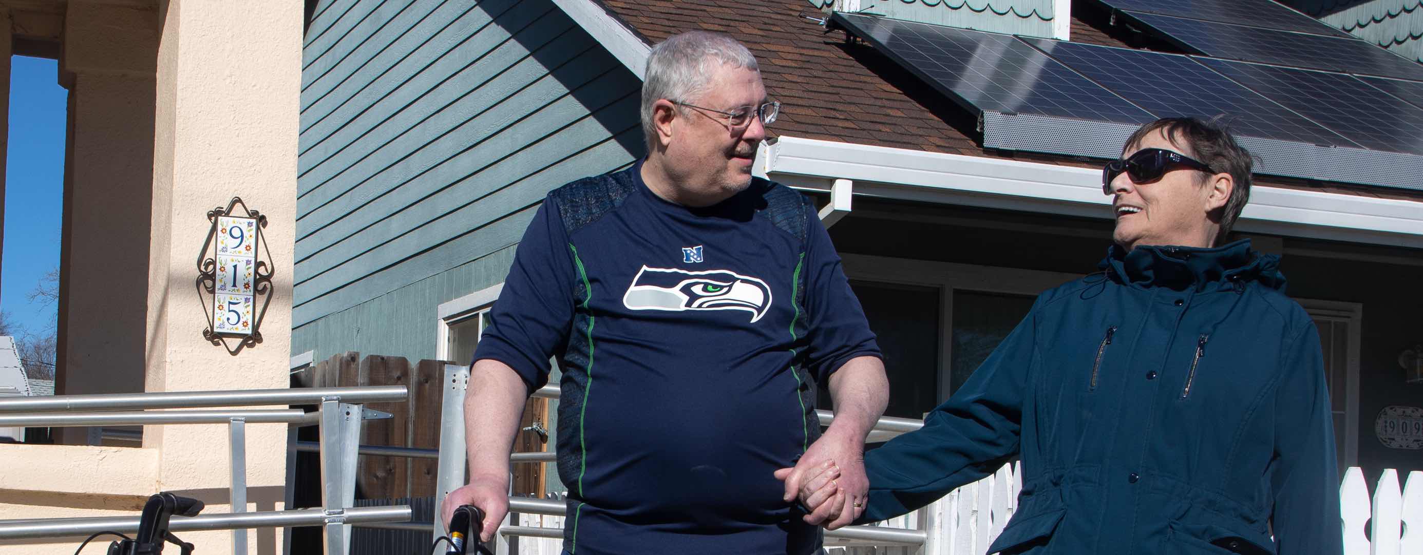 A man and woman walking on a sidewalk